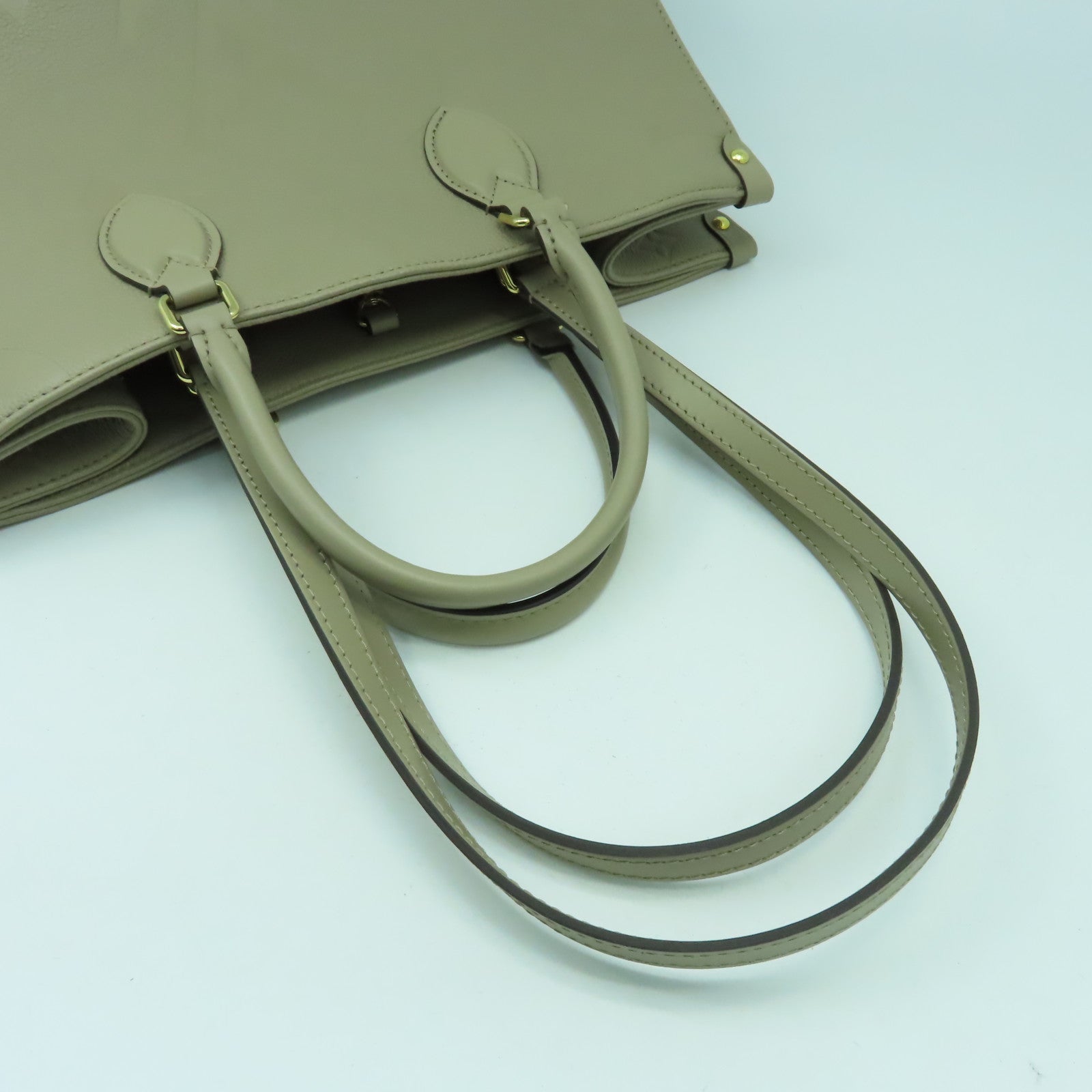 LOUIS VUITTON Monogram Empreinte On The Go MM金扣手挽肩背兩用袋米色