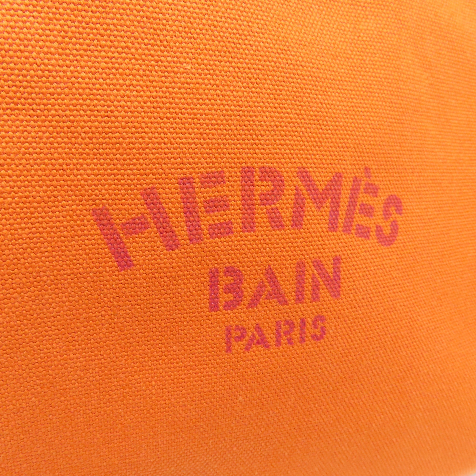 HERMES 帆布Bain Pouch金扣手拿包橙色