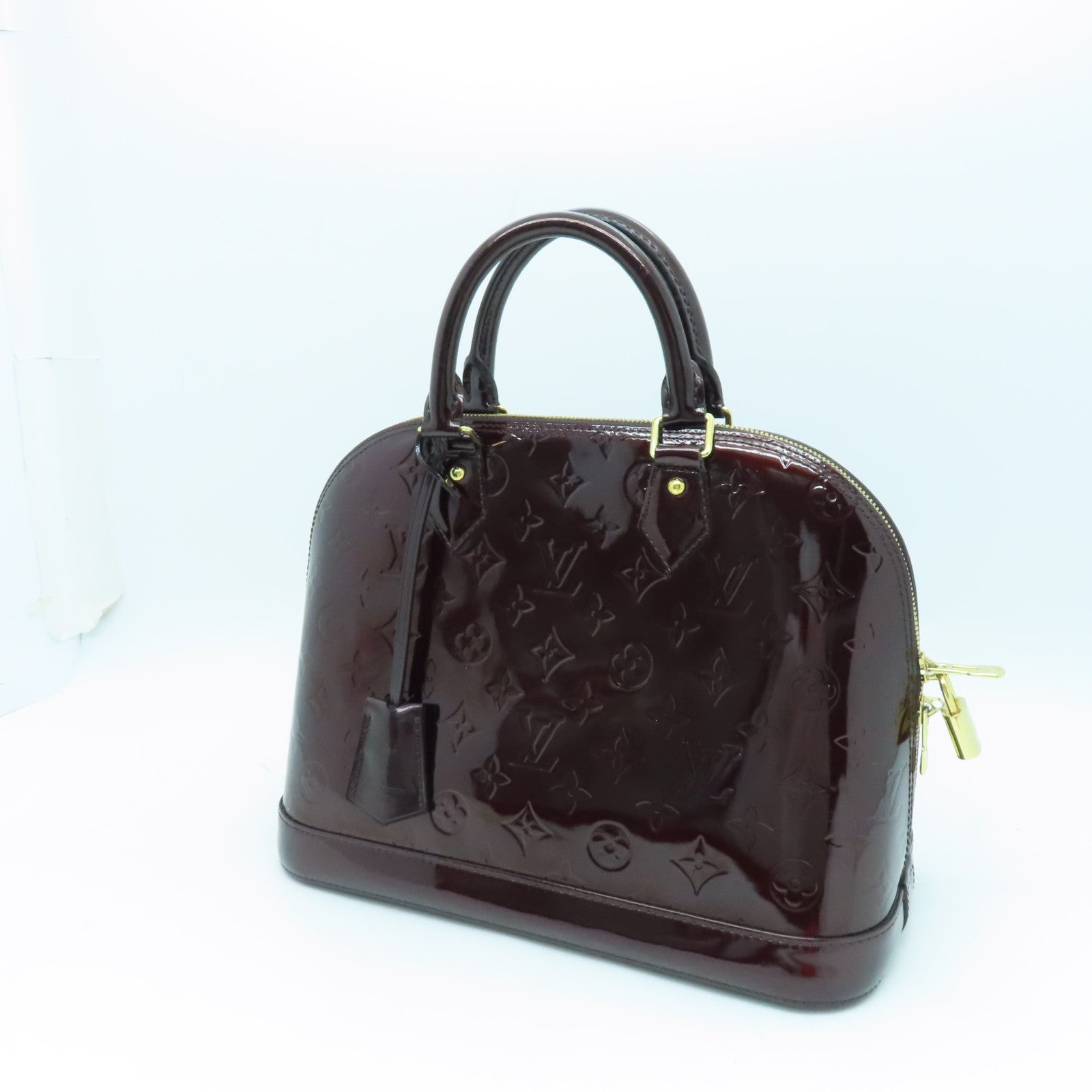 LOUIS VUITTON Monogram Vernis Alma PM gold buckle handle bag crimson