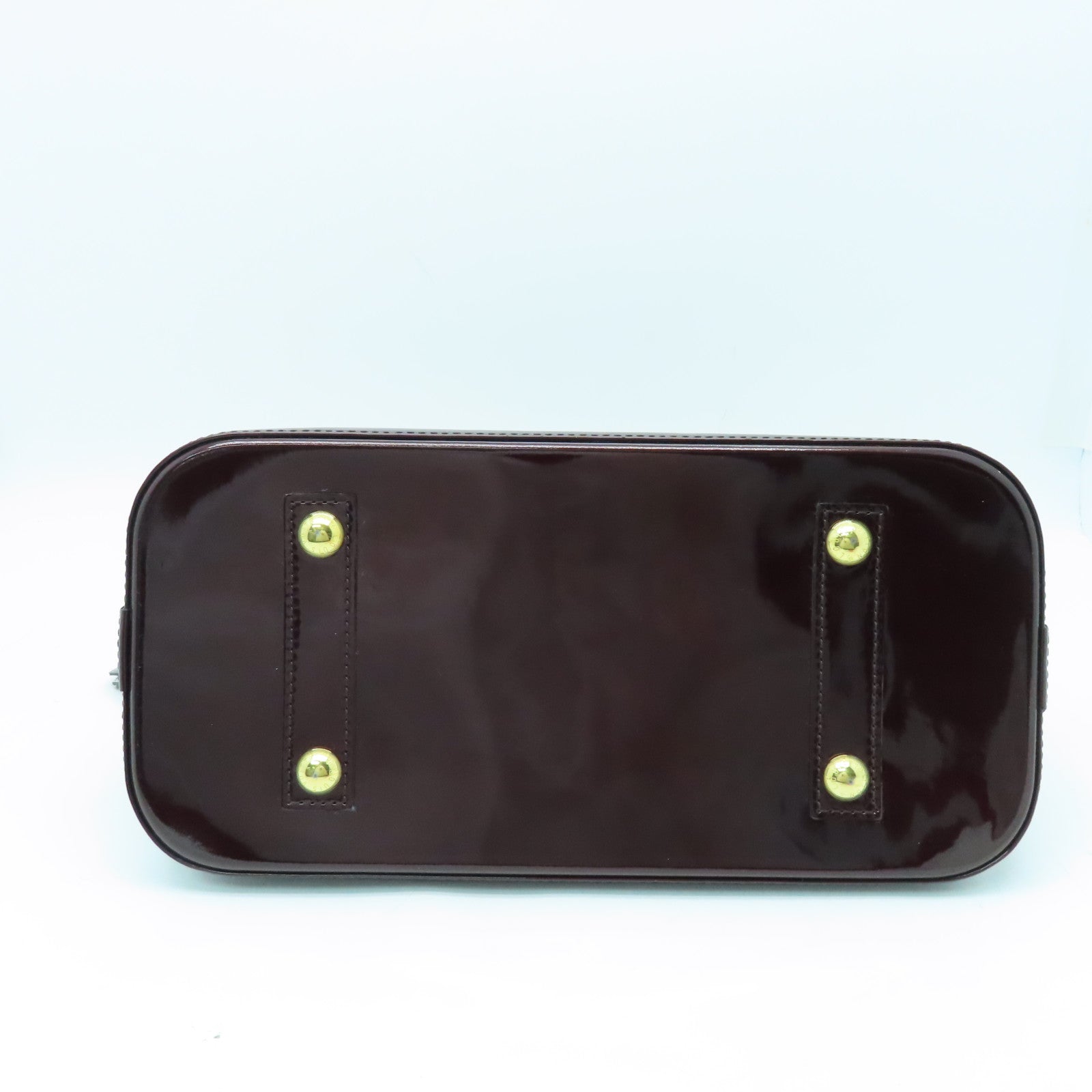 LOUIS VUITTON Monogram Vernis Alma PM gold buckle handle bag crimson