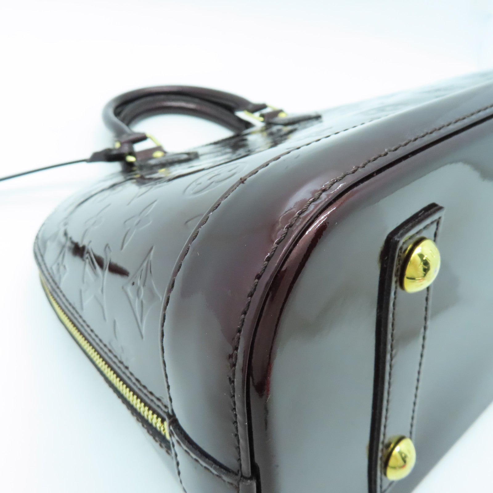 LOUIS VUITTON Monogram Vernis Alma PM gold buckle handle bag crimson