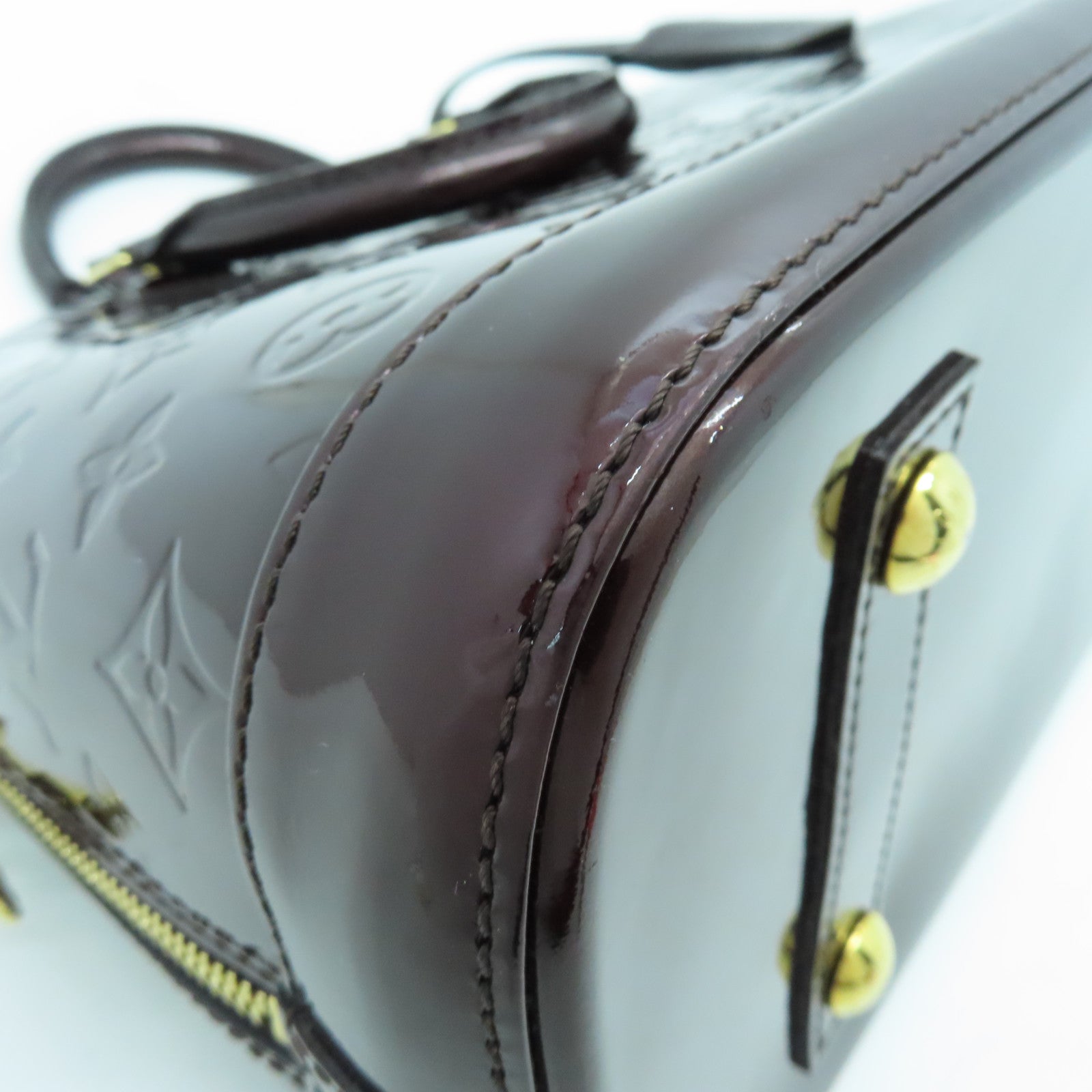 LOUIS VUITTON Monogram Vernis Alma PM gold buckle handle bag crimson