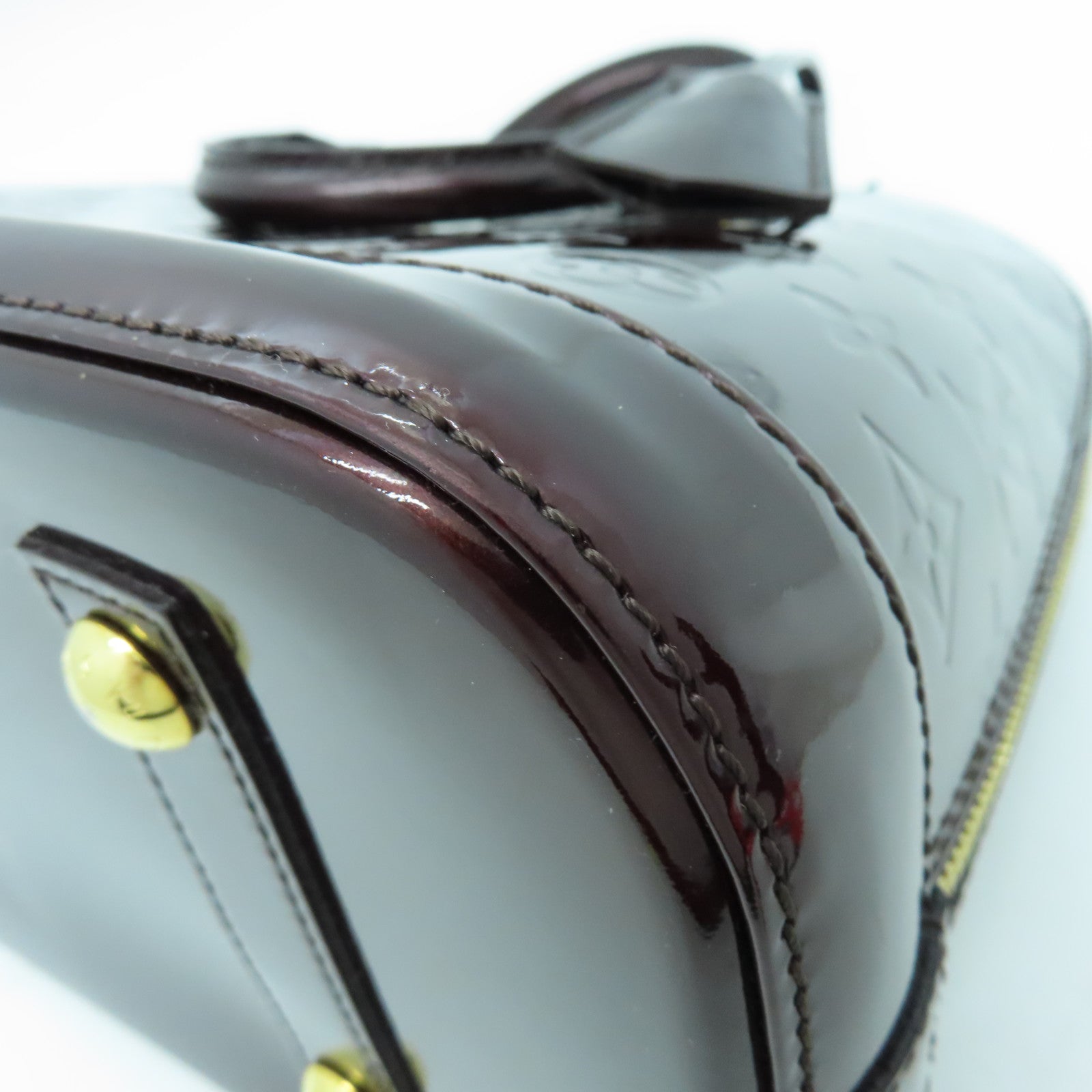 LOUIS VUITTON Monogram Vernis Alma PM gold buckle handle bag crimson