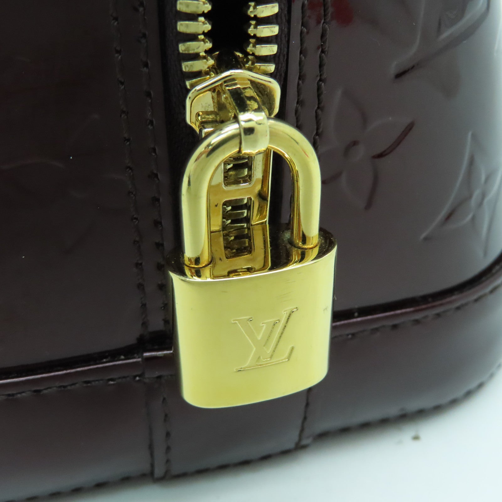 LOUIS VUITTON Monogram Vernis Alma PM gold buckle handle bag crimson